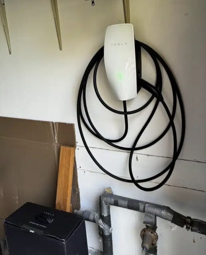 Tesla Wall Connector mounted in a garage with the cable looped, Clark County WA